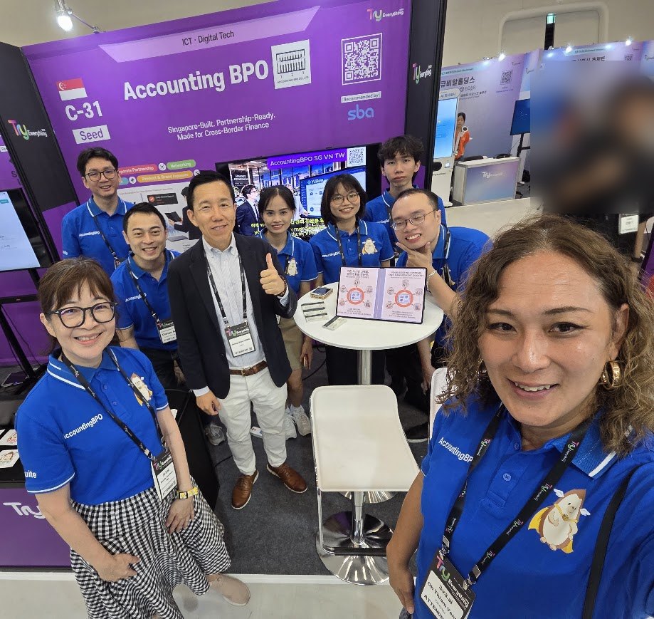 The AccountingBPO team in matching blue Yi shirts at their booth, C-31, at Try Everything 2026 in Seoul. The booth reads: Singapore-Built. Partnership-Ready. Made for Cross-Border Finance, and Recommended by SBA.